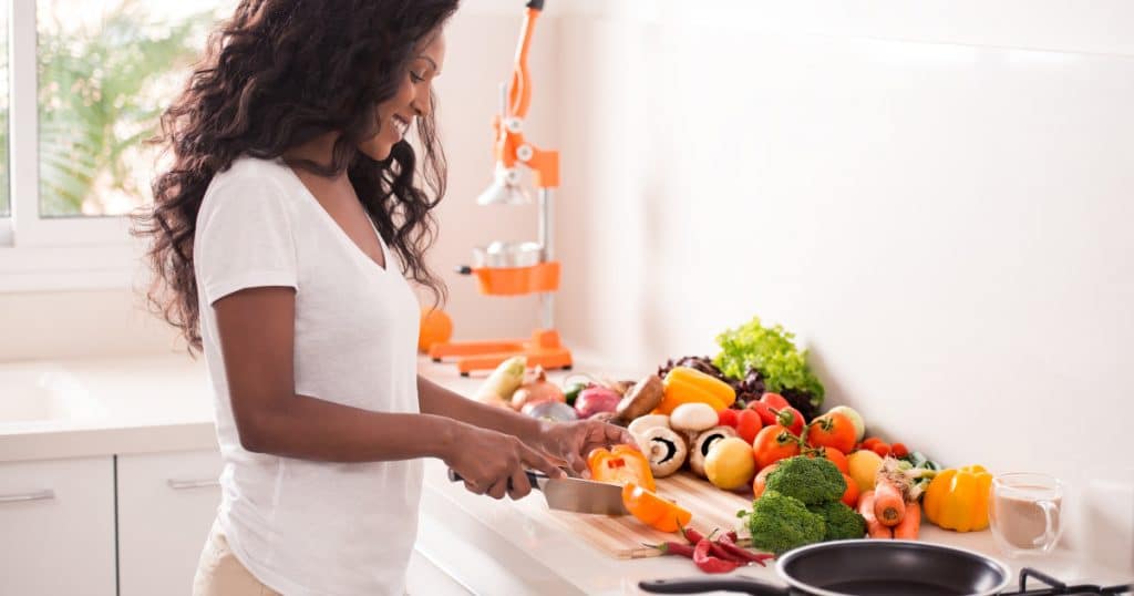 woman preparing healthy foods in a kitchen